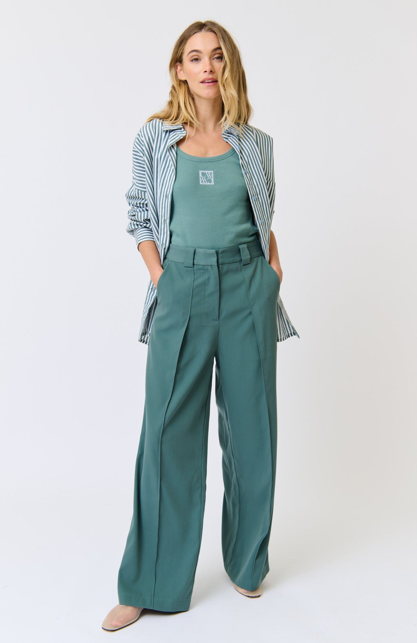 Woman wearing a green outfit with a white background